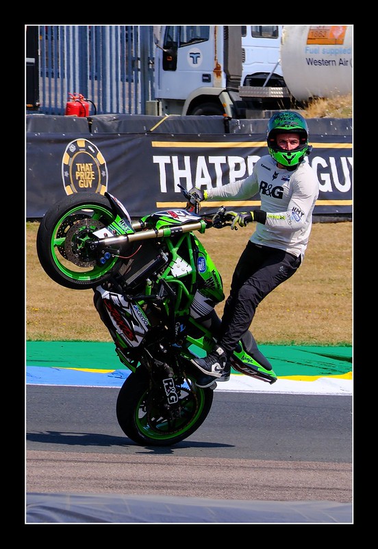 Motorcycle rider performing a wheelie at Thruxton Circuit